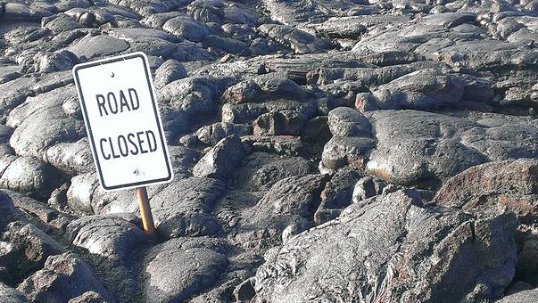 Picture of a sign amongst rocks